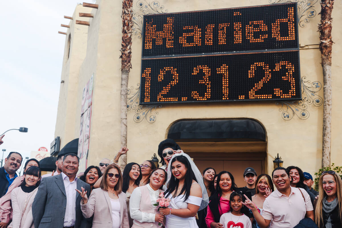 Anamarie Popoca, left, and Michelle Antonio, right, kiss after their wedding with their friends ...