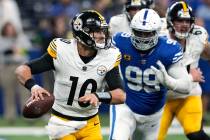 Pittsburgh Steelers quarterback Mitch Trubisky (10) rolls out, looking to pass, with Indianapol ...