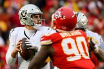 Las Vegas Raiders quarterback Aidan O'Connell looks to pass during the second half of an NFL fo ...