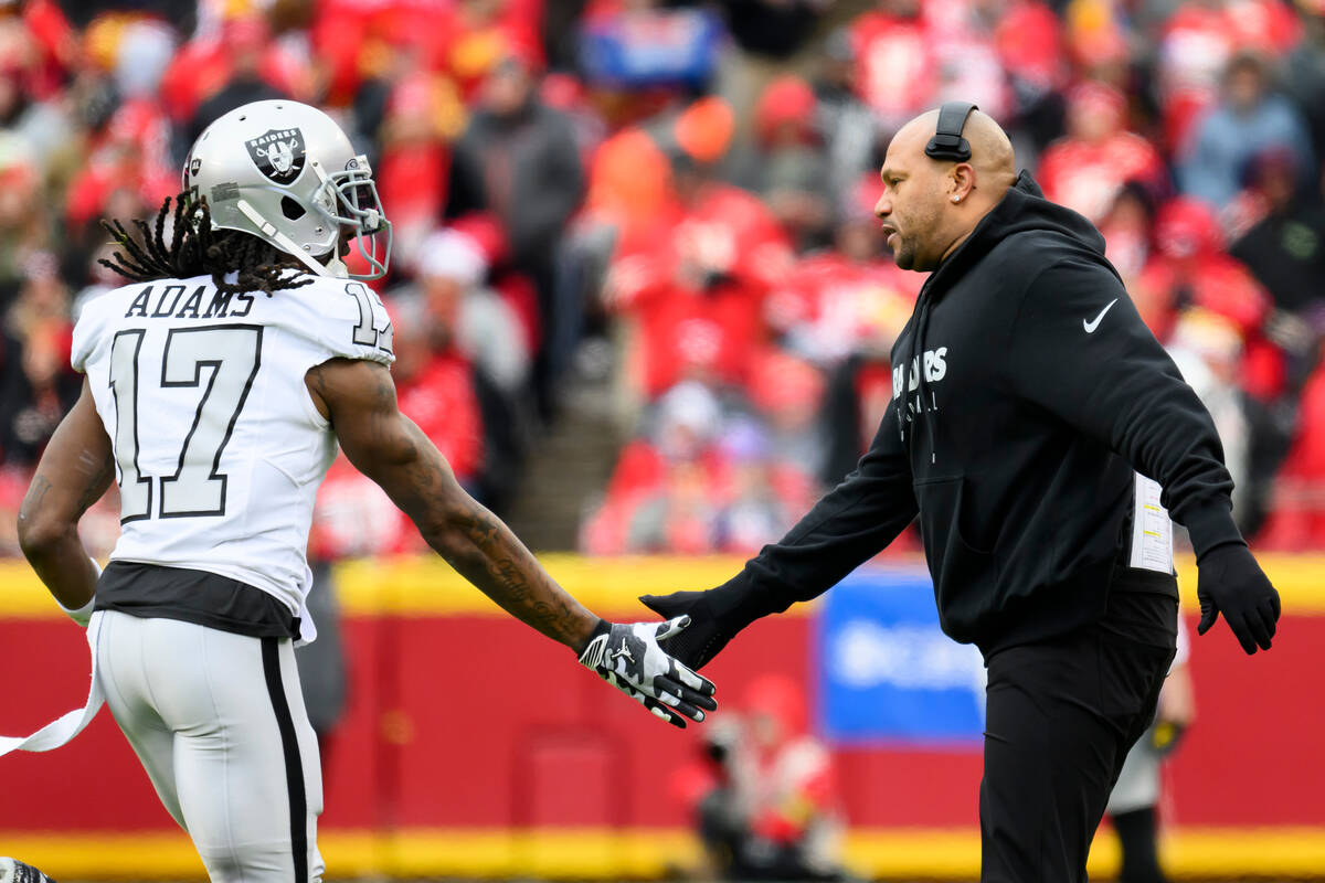 Las Vegas Raiders interim head coach Antonio Pierce congratulates Raiders wide receiver Davante ...