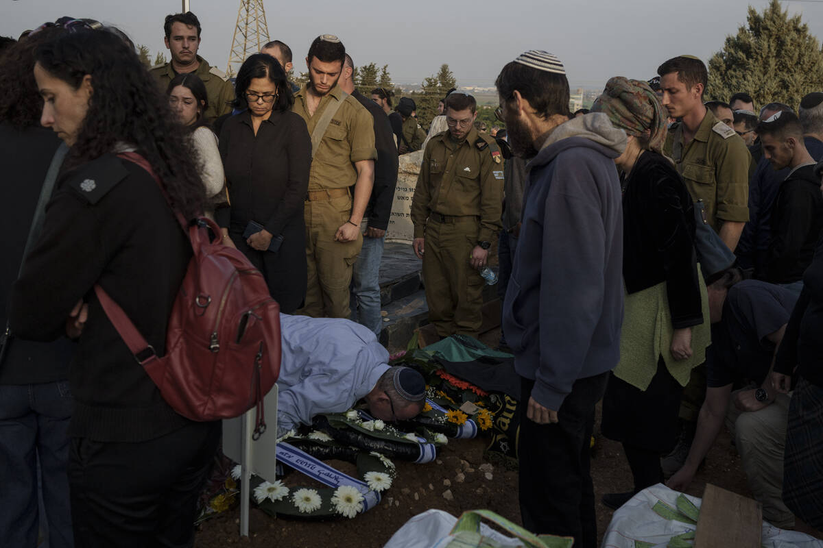 Relatives and friends mourn during the funeral of the Israeli Captain Neriya Zisk, at a cemeter ...