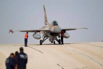 FILE - In this Monday, Nov 25, 2013, file photo, technicians inspect an Israeli air force F-16 ...