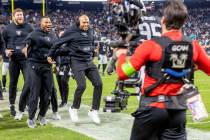 Raiders head coach Antonio Pierce jumps to celebrate as defensive tackle John Jenkins (95) retu ...