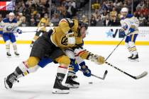Golden Knights center Paul Cotter (43) loses control of the puck to Sabres defenseman Ryan John ...