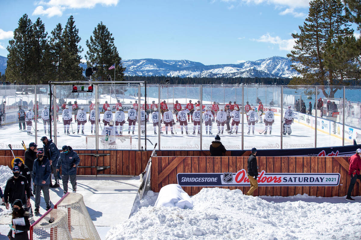 Vegas Golden Knights and Colorado Avalanche line up on the outdoor rink for the national anthem ...