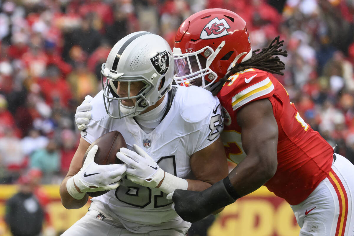Las Vegas Raiders tight end Austin Hooper (81) is tackled after making a catch by Kansas City C ...