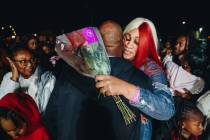 Keonta Cook, the mother of Keon Young, hugs a mourner during a vigil for her son at Desert Hori ...