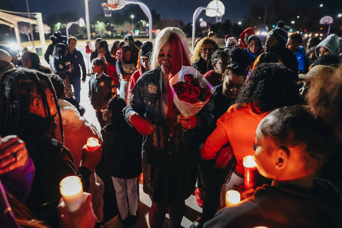 Keonta Cook, the mother of Keon Young, walks towards a group of mourners during a vigil for her ...