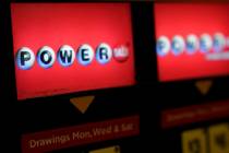 A lottery ticket vending machine is seen in a convenience store in Northbrook, Ill. (AP Photo/N ...