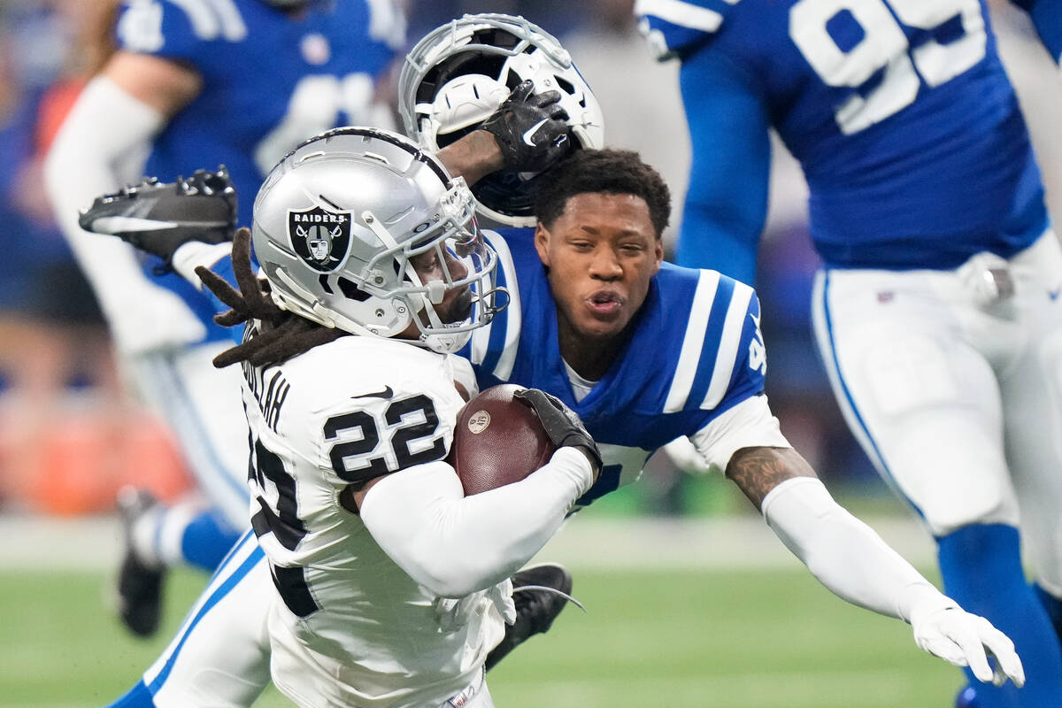 Indianapolis Colts cornerback Jaylon Jones, right, loses his helmet as he tackles Las Vegas Rai ...