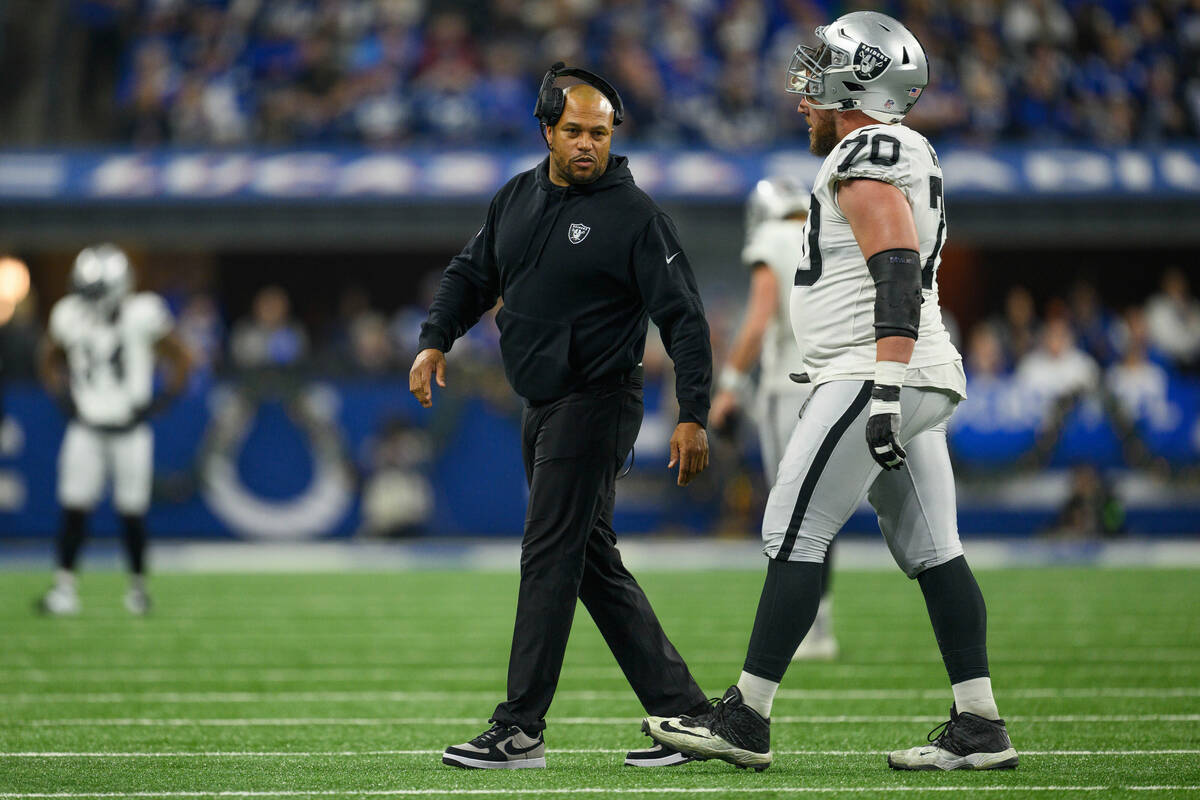 Las Vegas Raiders interim head coach Antonio Pierce talks to Las Vegas Raiders guard Greg Van R ...