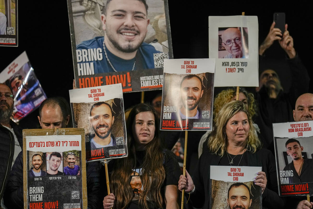 Families and supporters of Israeli hostages held by Hamas in Gaza hold their photos and shout s ...