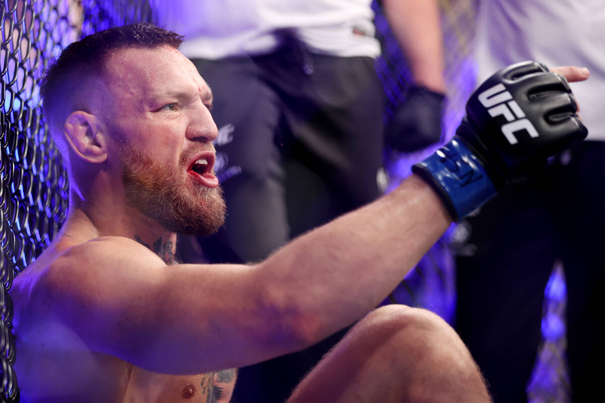 Conor McGregor yells after hurting his foot in the first round of a lightweight bout against Du ...