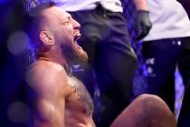 Conor McGregor yells in pain after hurting his foot in the first round of a lightweight bout ag ...