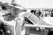 FILE - Cale Yarborough walks away after blowing the engine of his Oldsmobile just after complet ...
