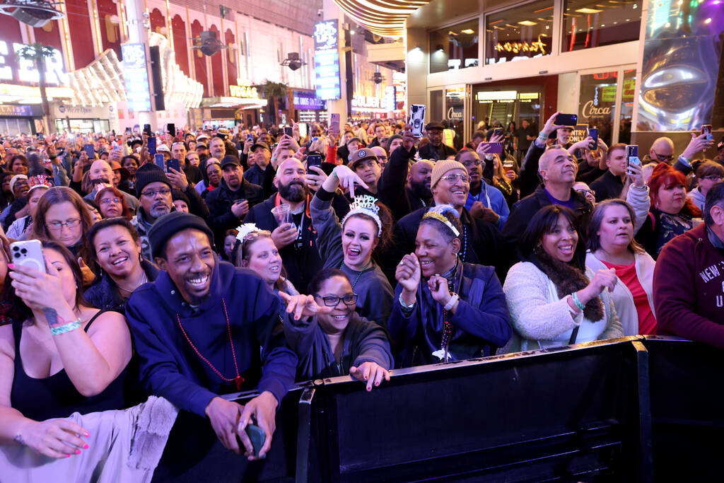 New Year’s Eve revelers listen to Color Me Badd on the First Street Stage during the Tim ...