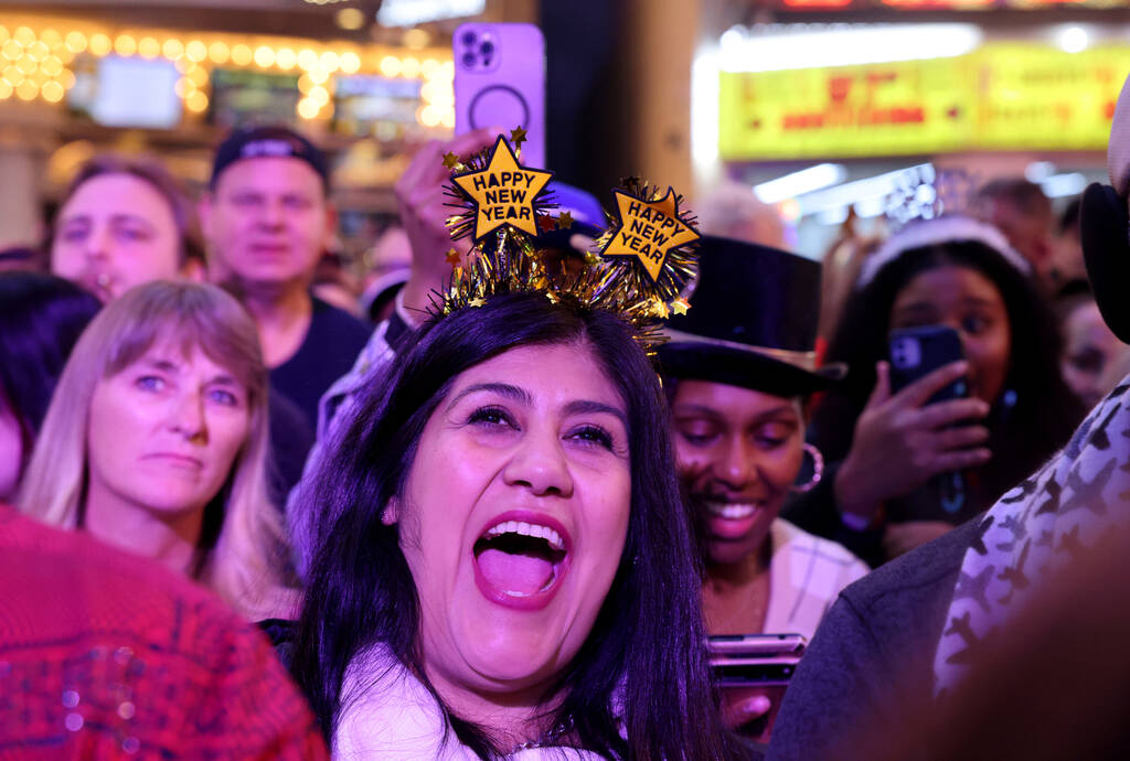 New Year’s Eve revelers, including Corina Garcia Imperial, Calif., listen to Color Me Ba ...