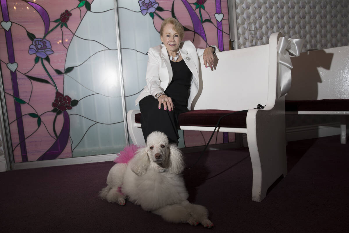 Charolette Richards, owner of A Little White Wedding, with her dog at her Las Vegas business, W ...