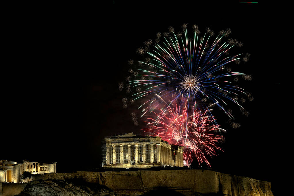 Fireworks explode over the ancient Parthenon temple at the Acropolis hill during New Year's cel ...