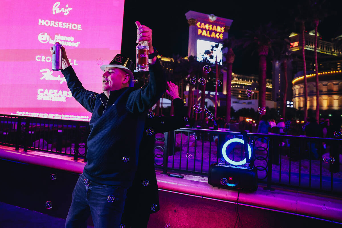 New Year revelers dance in front of Harrah’s on Sunday, Dec. 31, 2023, in Las Vegas. (Ma ...