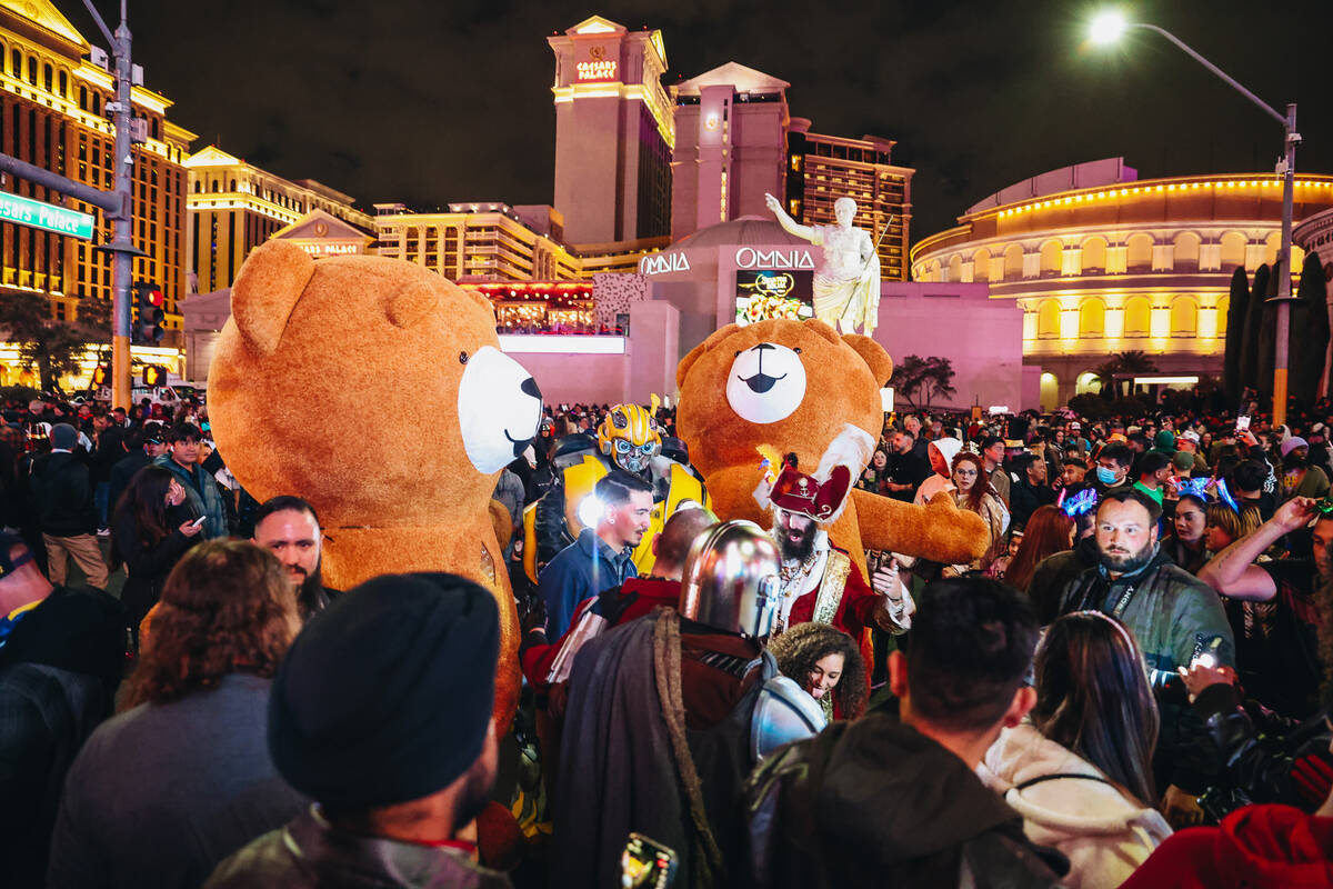Buskers are seen on the Strip as crowds fill in for New Year’s Eve celebrations on Sunda ...