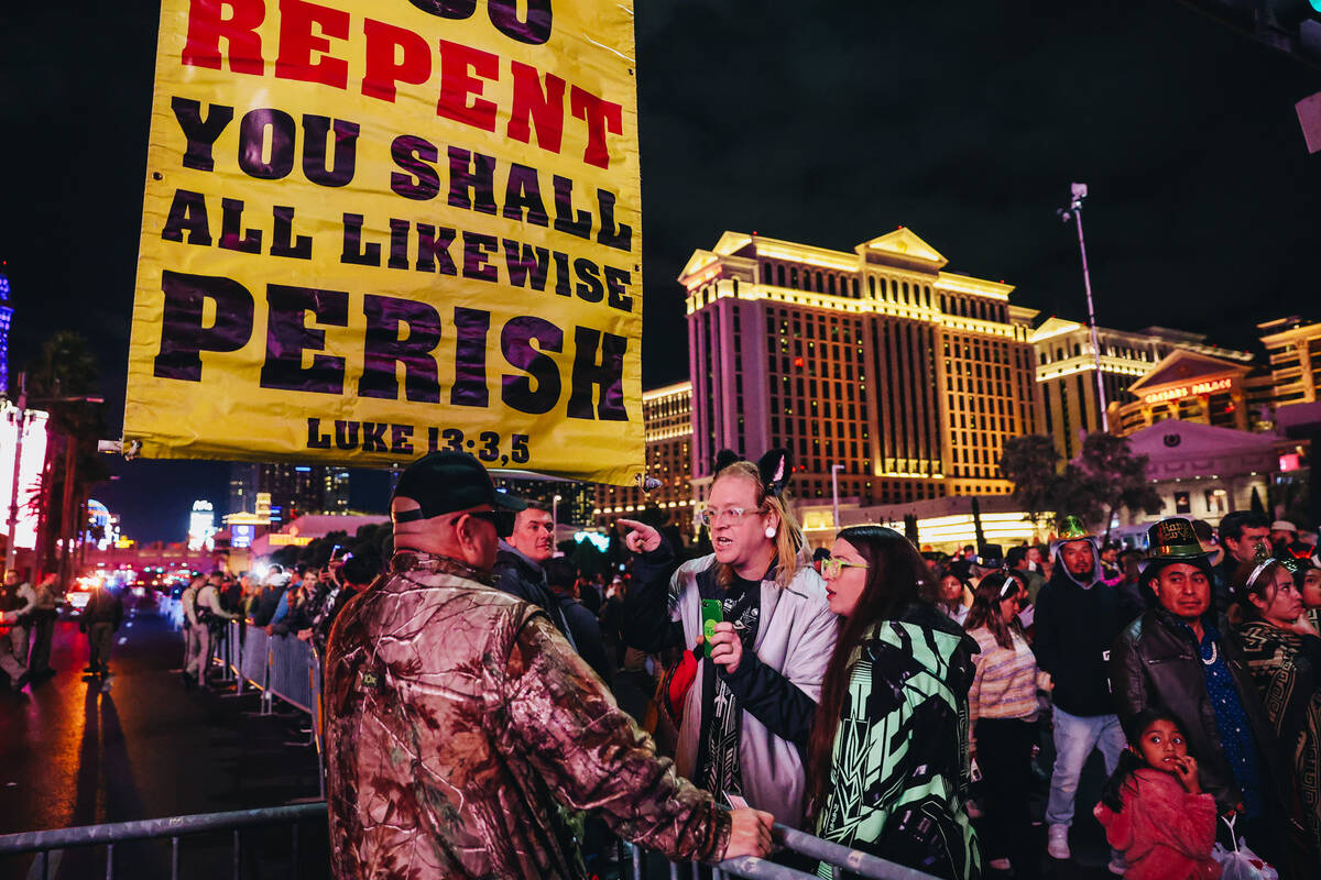 A demonstrator is challenged by a New year’s Eve reveler on the Strip on Sunday, Dec. 31 ...