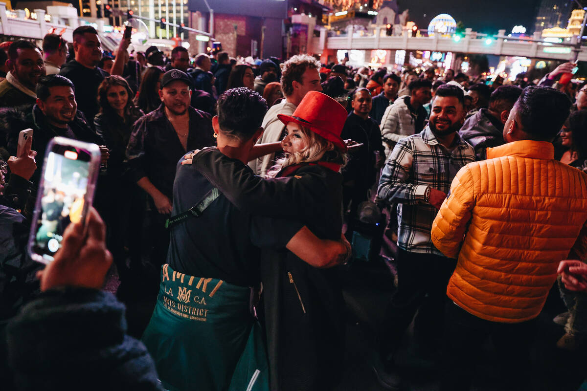 New Year’s revelers dance in the middle of the Strip as midnight nears on Sunday, Dec. 3 ...