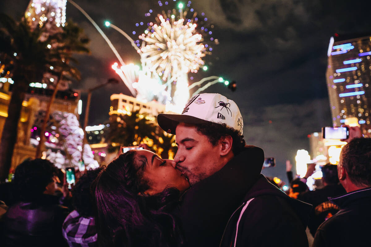 Reonna Holmes, left, kisses her boyfriend, Eric Lovato at midnight as New Year’s firewor ...