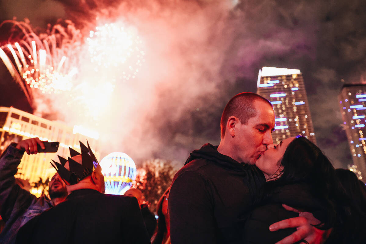 A couple kisses at midnight while New Years fireworks go off on the Strip on Monday, Jan. 1, 20 ...