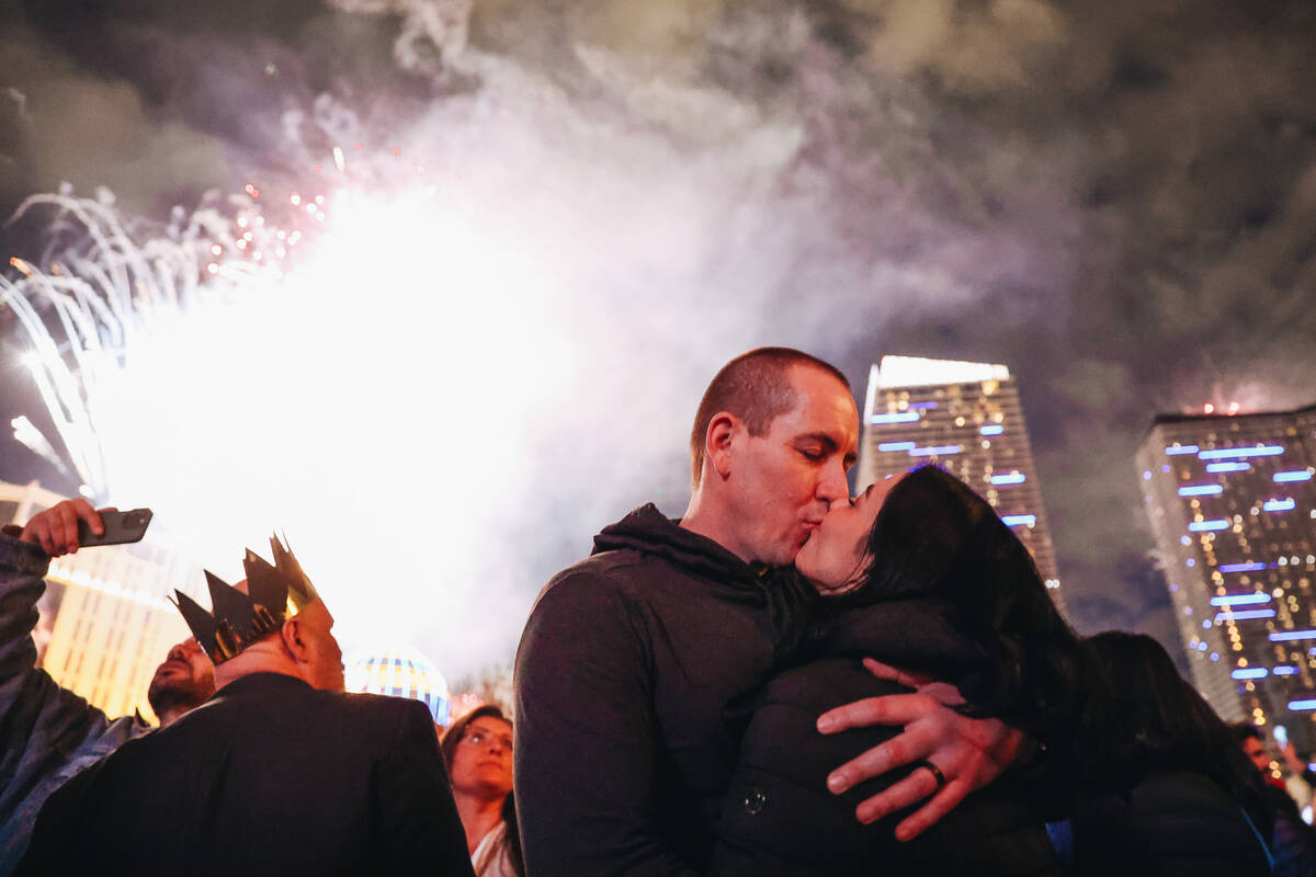 A couple kisses at midnight while New Years fireworks go off on the Strip on Monday, Jan. 1, 20 ...