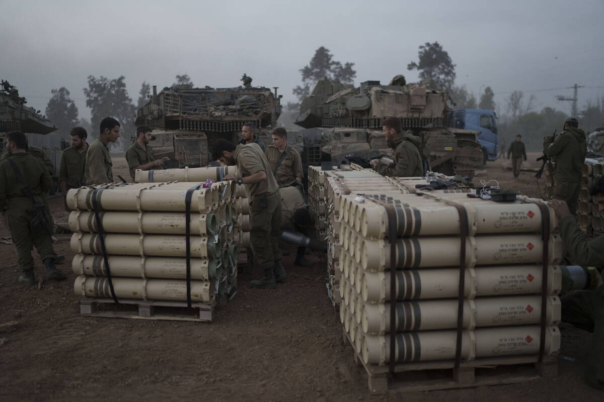 Israeli soldiers from the artillery unit store tank shells in a staging area at the Israeli-Gaz ...