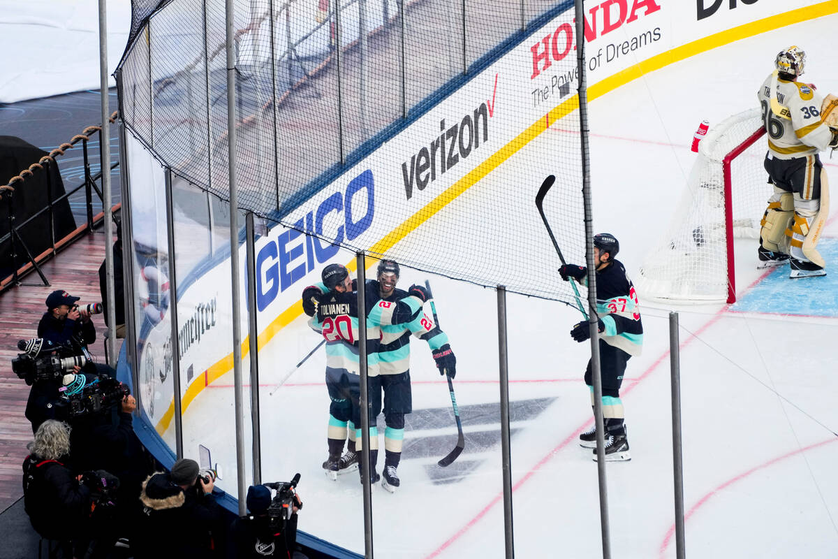 Seattle Kraken right wing Eeli Tolvanen (20) celebrates his goal with teammates right wing Oliv ...