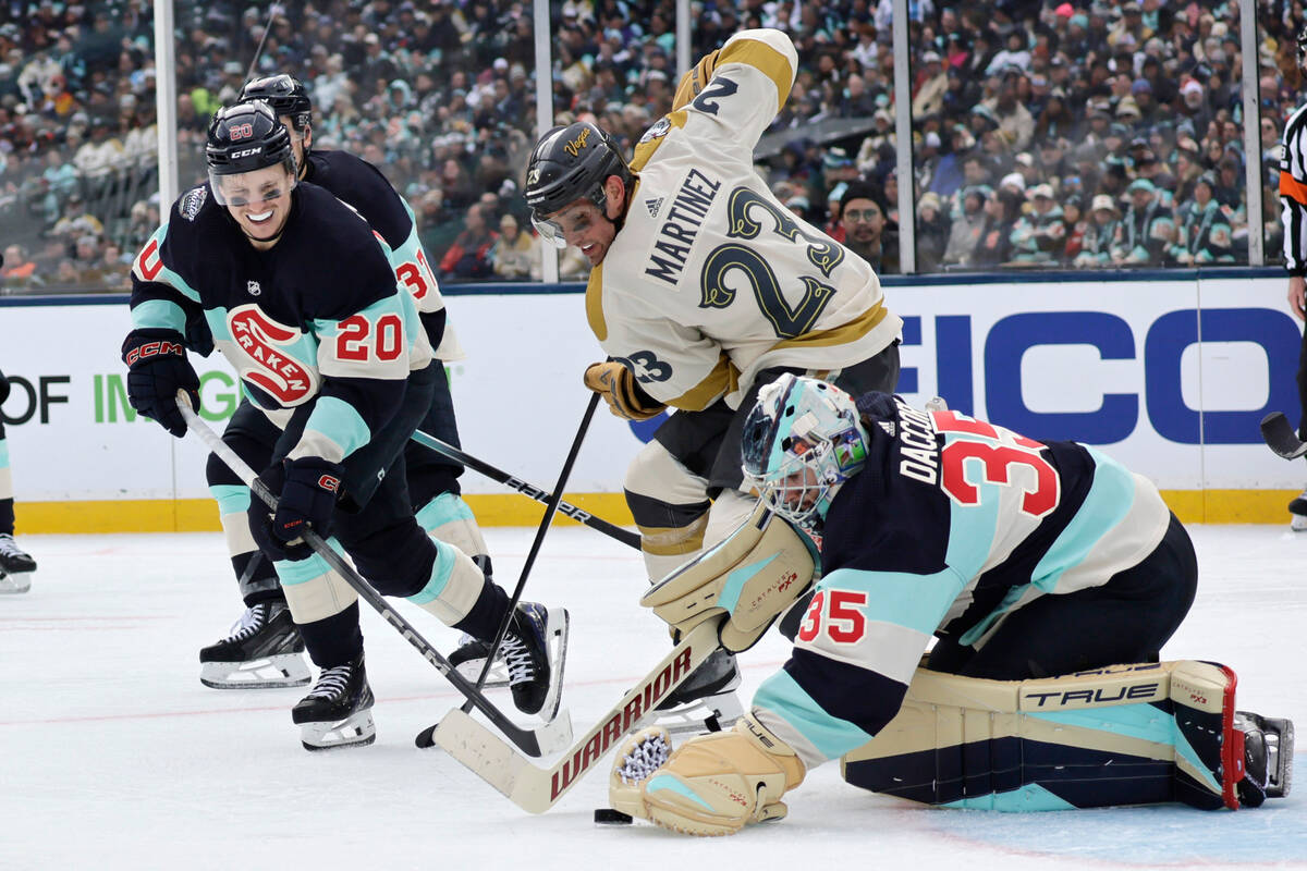 Seattle Kraken goaltender Joey Daccord (35) reaches for the puck with right wing Eeli Tolvanen ...