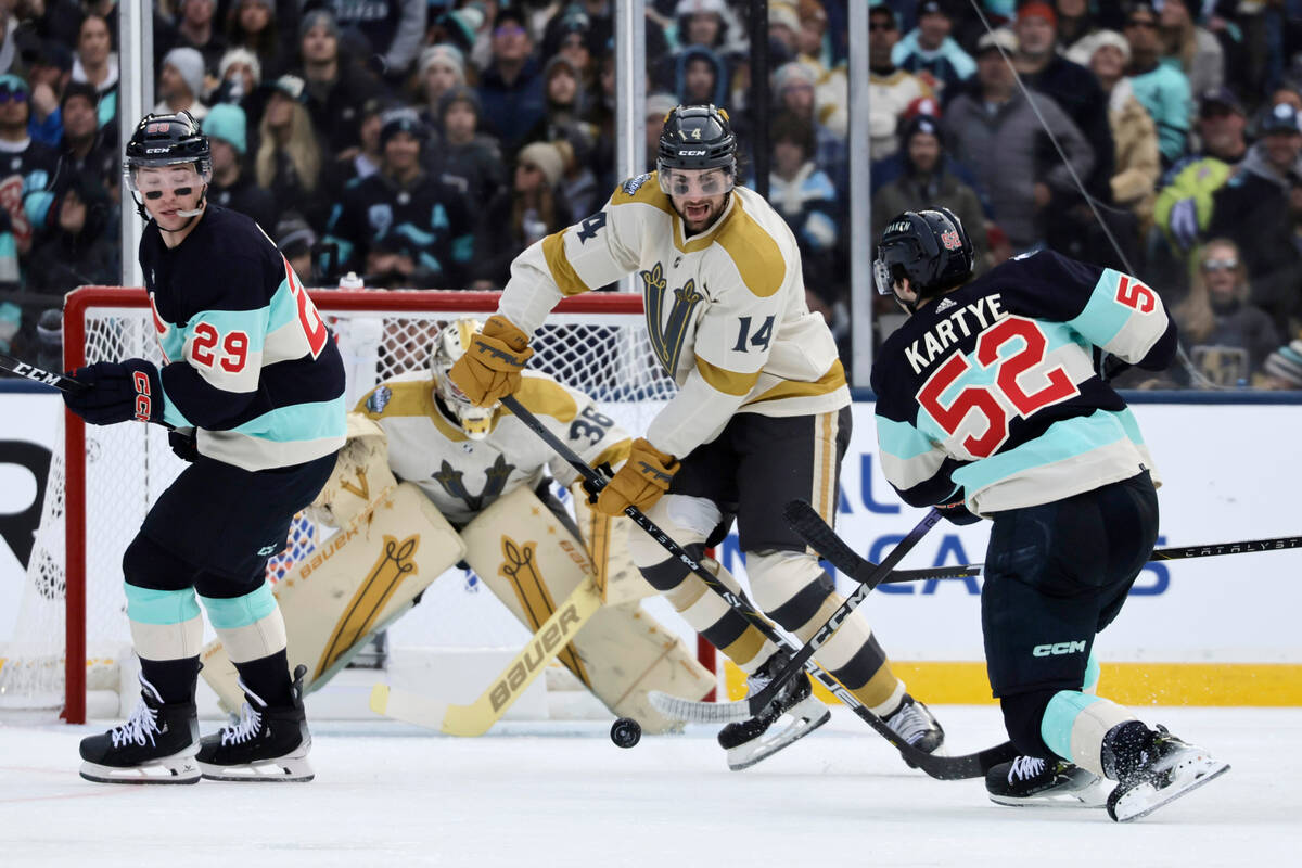 Seattle Kraken left wing Tye Kartye (52) shoots on goal with Vegas Golden Knights defenseman Ni ...