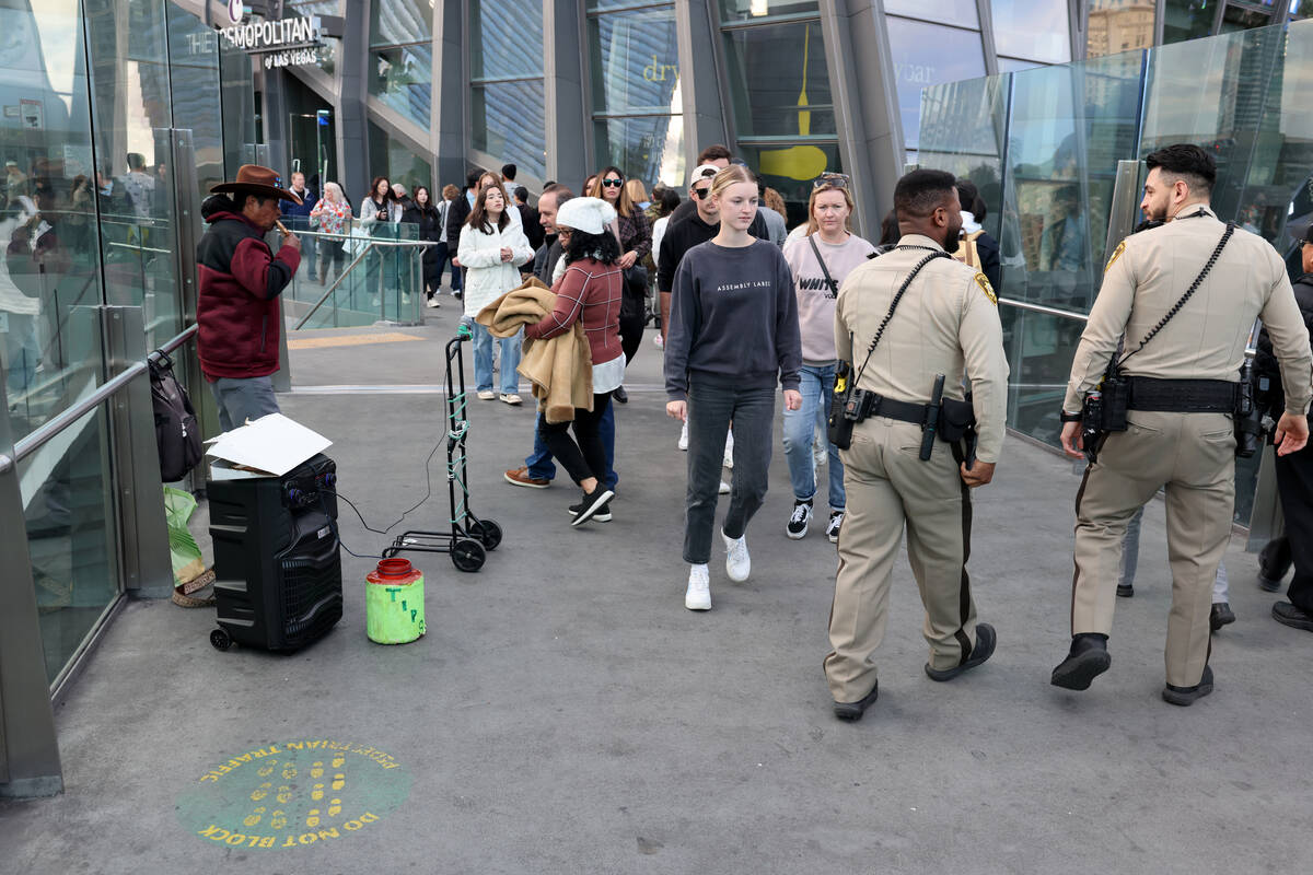 An entertainer plays music on a pedestrian bridge above the Strip at Harmon Avenue in Las Vegas ...