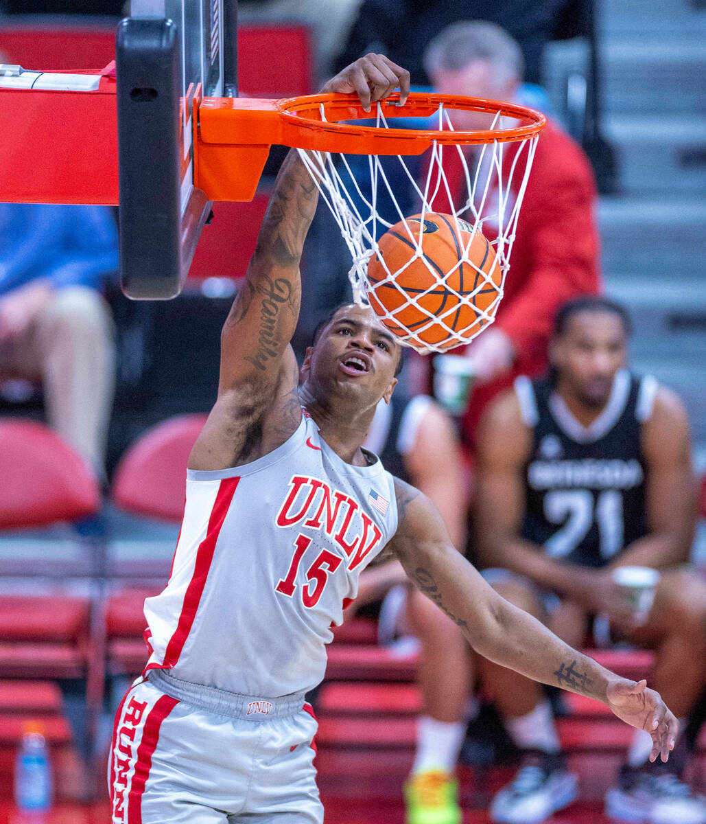UNLV Rebels guard Luis Rodriguez (15) dunks the ball over the Bethesda University Flames during ...