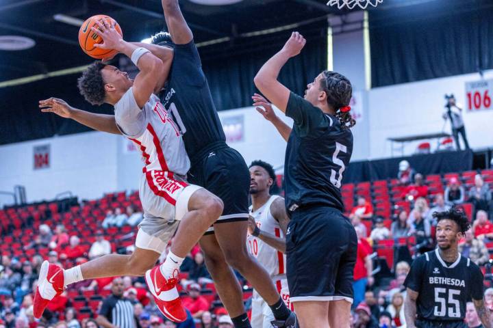 UNLV Rebels guard Dedan Thomas Jr. (11) battles to get off a shot against Bethesda University F ...