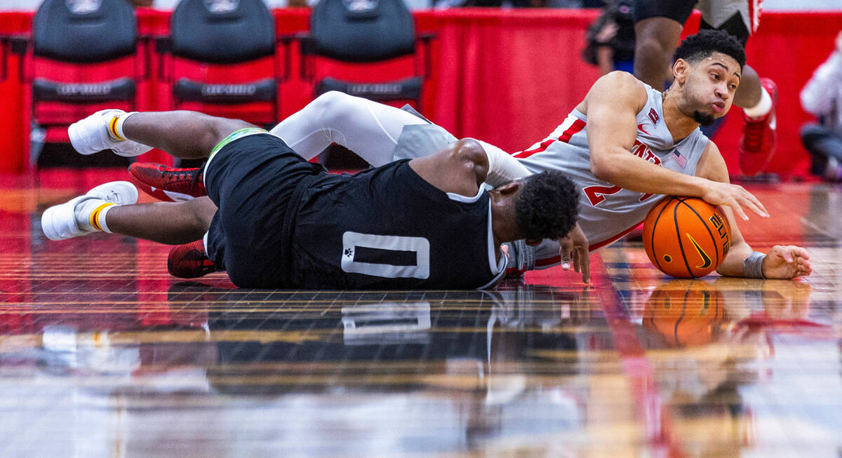 UNLV Rebels guard Justin Webster (2) grabs possession of a loose ball from Bethesda University ...