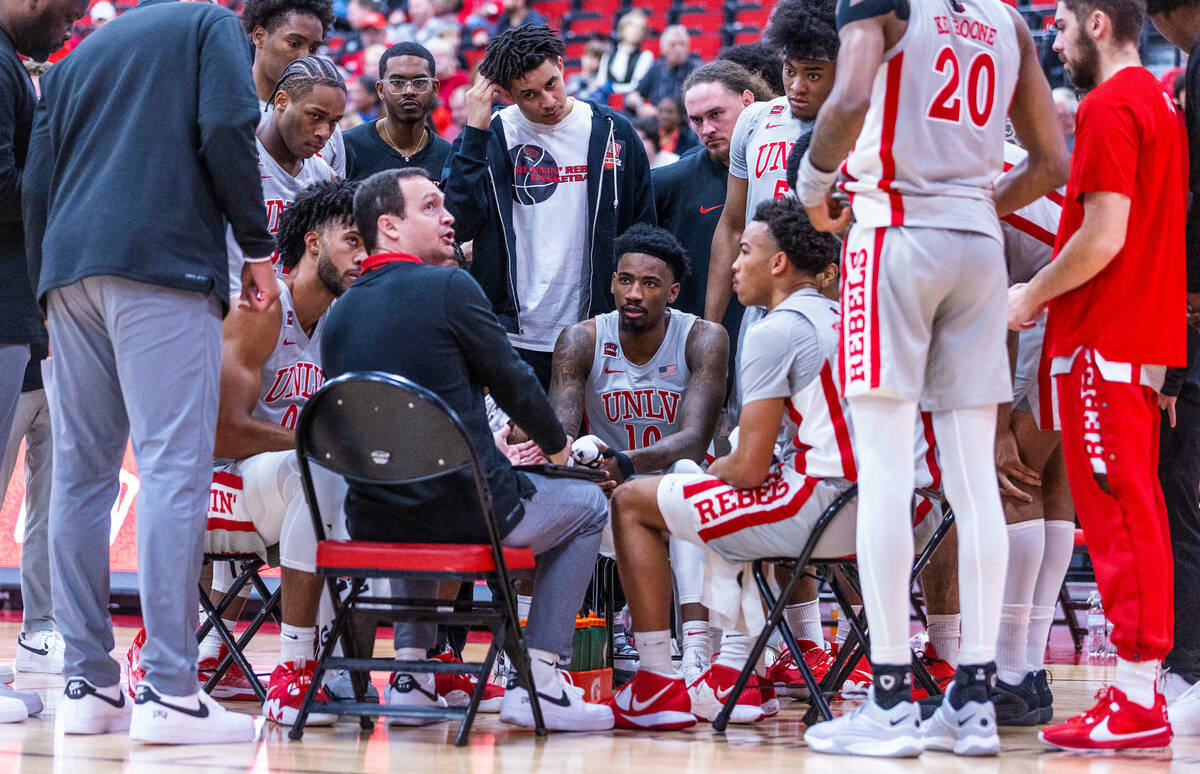 UNLV Rebels head coach Kevin Kruger and players gather on a timeout against the Bethesda Univer ...