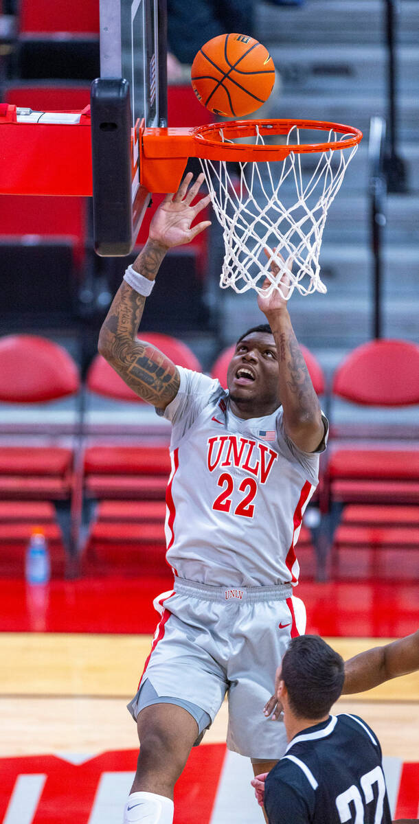 UNLV Rebels forward Karl Jones (22) taps a rebound in over Bethesda University Flames guard Eda ...