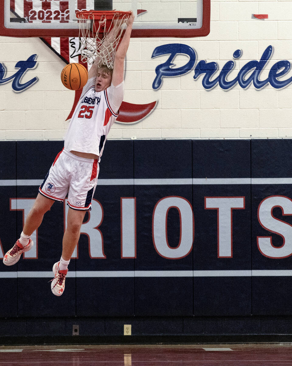 Liberty forward Tyler Bright (25) dunks during the first half of a boys high school basketball ...