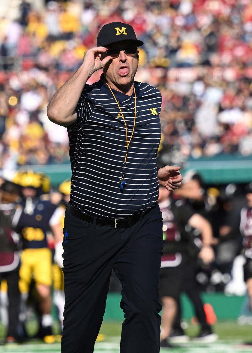 Michigan head coach Jim Harbaugh runs on the field before the Rose Bowl CFP NCAA semifinal coll ...