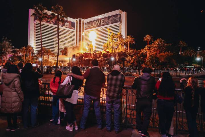 People watch the Mirage volcano go off on Sunday, Dec. 31, 2023, in Las Vegas. (Madeline Carter ...