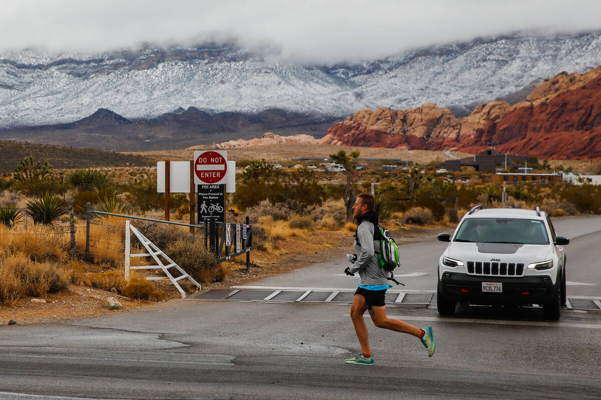 A runner jogs through Red Rock Canyon after a dusting of snow on Wednesday, Jan. 3, 2024, in La ...