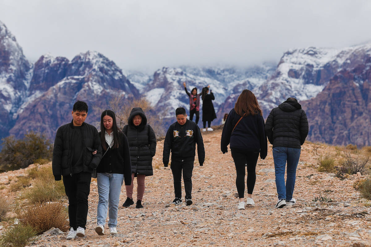 Visitors explore Red Rock Canyon after a dusting of snow blankets the mountains on Wednesday, J ...