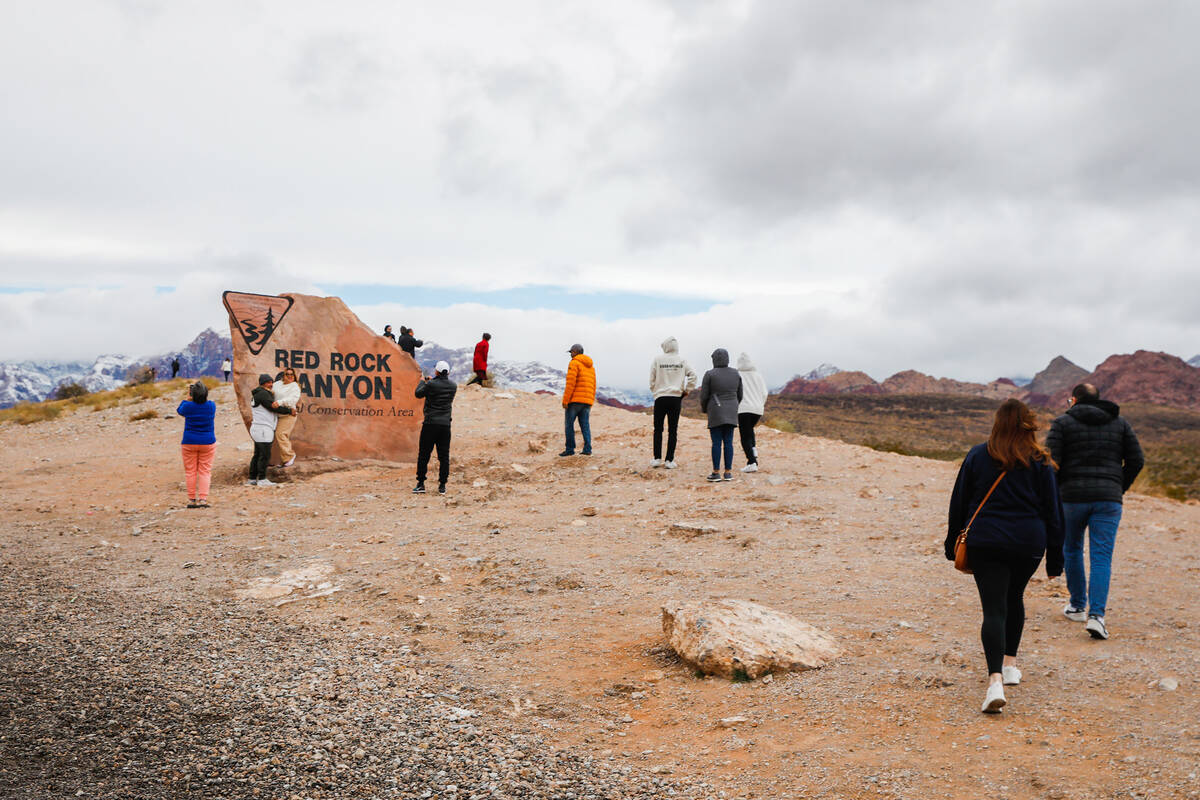 Visitors explore Red Rock Canyon after a dusting of snow blankets the mountains on Wednesday, J ...