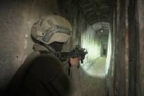 FILE - Israeli soldiers show the media an underground tunnel found underneath Shifa Hospital i ...