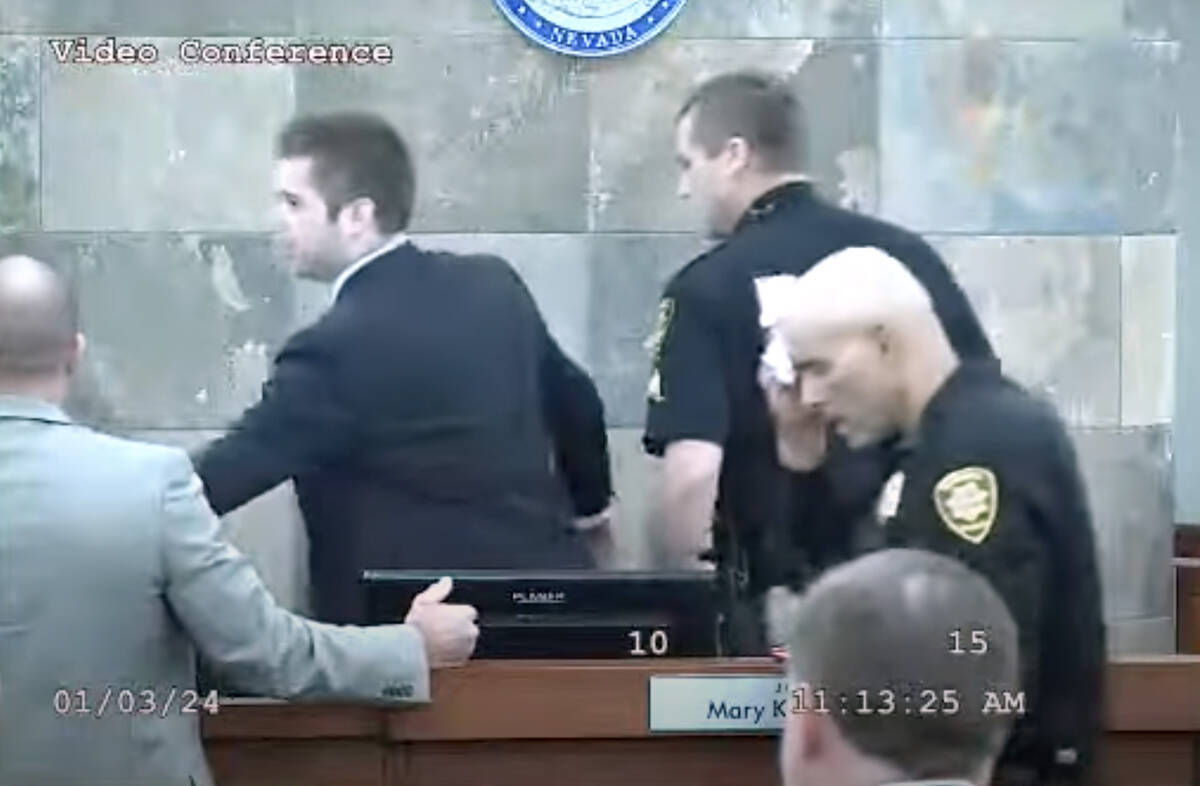 This is a video screen shot of a court marshal dabbing his forehead after defendant Deobra Redd ...