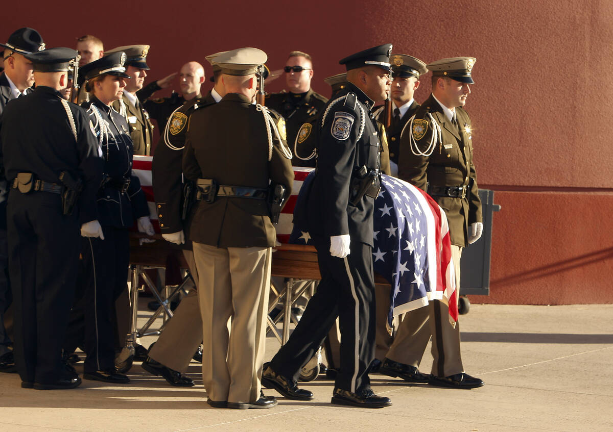 Las Vegas police officers escort the casket of slain court security officer Stan Cooper into th ...