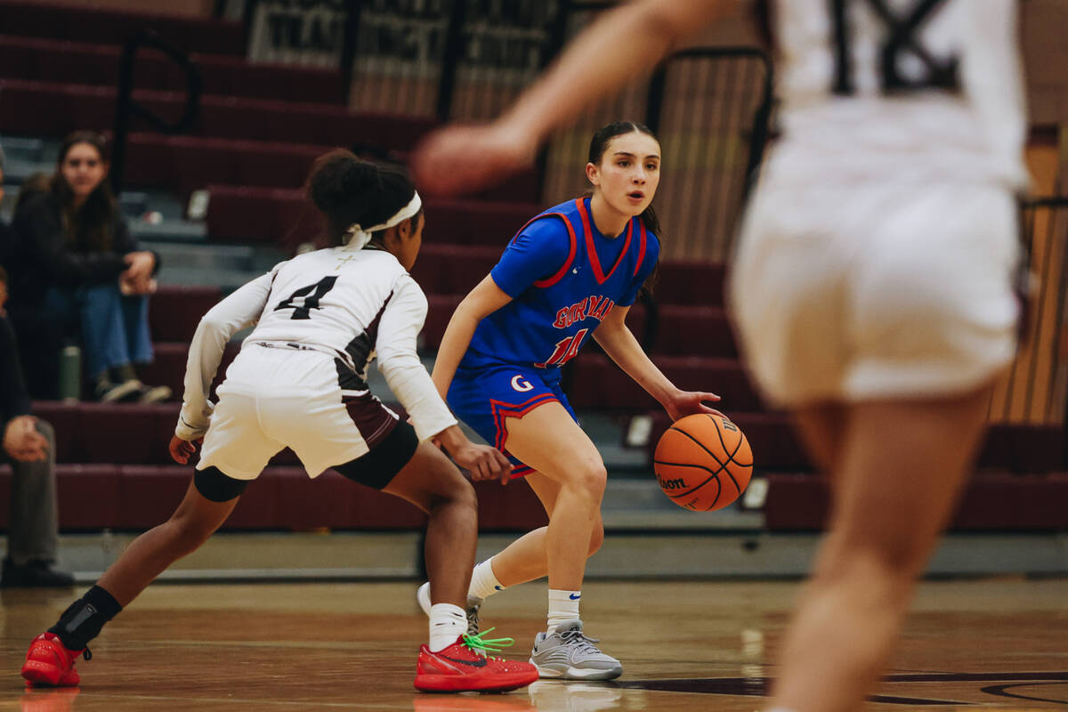Bishop Gorman point guard Kenzee Holton looks to pass the ball to a teammate during a game at F ...